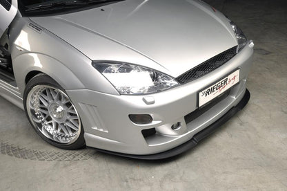 Ford Focus 1 Rieger Spoilerstoßstange -> bis Modell 10/2001 mit Aussparung für Blinkleuchten, mit seitlichen Rippen, ABS, für Fzg. mit Scheinwerferreinigungsanlage, 
inkl. Alugitter, Montagezubehör, ABE